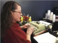  ??  ?? In this April 23, 2017photo, Andrea Kittle, of Albuquerqu­e, N.M., tries out a vintage Smith Corona electric typewriter at a “type-in” in Albuquerqu­e. “Type-ins” are social gatherings in public places where typewriter fans test different vintage machines.