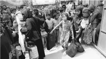  ?? — Reuters photo ?? Rohingya refugees collect aid supplies including food and medicine, sent from Malaysia at Kutupalang Unregister­ed Refugee Camp in Cox’s Bazar, Bangladesh.