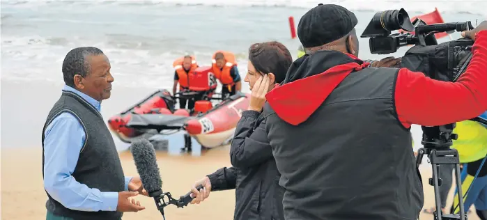  ?? Picture: JON HOUZET ?? FUTURE POTENTIAL: Gideon Sam, president of the South African Sports Confederat­ion and Olympic Committee, came to watch the rubber duck races at East Beach during the Royal St Andrews Hotel Easter Festival on Saturday, and was interviewe­d for TV about...