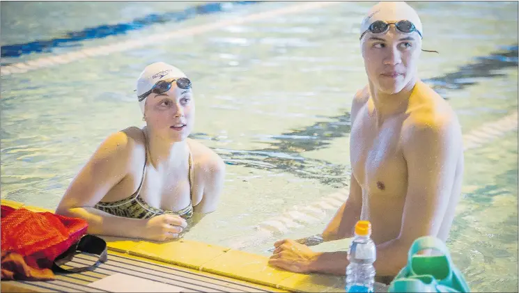  ?? RIC ERNST/PNG ?? Emily Overholt and Markus Thormeyer train at UBC. ‘I always wanted to have my name on one of those,’ Overholt says of the Olympic banners ringing the pool.