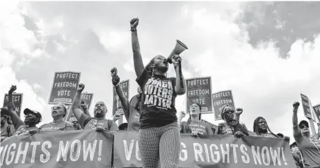  ?? KENNY HOLSTON/THE NEW YORK TIMES ?? Voting rights activists march Saturday on the National Mall in Washington. The Supreme Court’s 6-3 ruling Thursday will likely help Republican states fight challenges to voting restrictio­ns being put in place.