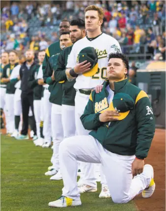  ?? Santiago Mejia / The Chronicle 2017 ?? Bruce Maxwell became the first major leaguer to take a knee to protest racial injustice when the then-A’s catcher did so during the national anthem before a game on Sept. 23, 2017.