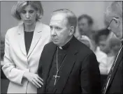  ?? MARK HENLE/ARIZONA REPUBLIC VIA AP ?? IN THIS MARCH 26, 2004, FILE PHOTO, Bishop Thomas O’Brien is flanked by attorneys Melissa Berren (left) and Tom Henze at a court hearing on a child sexual assault charge in Phoenix.