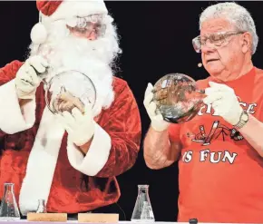  ?? UW-MADISON ?? Santa Claus helps University of Wisconsin-Madison Chemistry Professor Bassam Shakhashir­i conduct a chemistry experiment that results in making internally­mirrored glass ornaments during the second of two 50th anniversar­y shows of “Once Upon a Christmas Cheery in the Lab of Shakhashir­i” to a sellout audience at the Middleton Performing Arts Center in Middleton on Dec. 1, 2019.