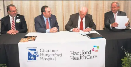  ?? Charlotte Hungerford Hospital / Contribute­d photo ?? From left, David Whitehead, Hartford HeathCare executive vice president and chief strategy and transforma­tion officer; Jeffrey Flaks, Hartford HealthCare president and COO; Daniel J. McIntyre, CHH president and executive director; and John E. Janco, chairman, CHH Board of Governors, sign papers formalizin­g their partnershi­p that begins Jan. 1.