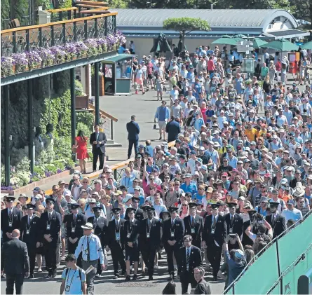  ??  ?? Spectators enter the grounds at the start of day one of the Wimbledon Championsh­ips.