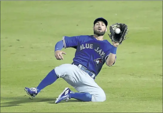  ?? JOHN BAZEMORE/AP ?? Toronto Blue Jays center fielder Kevin Pillar makes a sliding catch to retire Atlanta Braves’ Nick Markakis in the fifth inning of a baseball game, Tuesday in Atlanta.