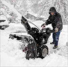  ?? RICK CINCLAIR/WORCESTER TELEGRAM & GAZETTE ?? Paul Horgan clears his driveway for the second time Tuesday morning as more than a foot of snow continued to fall in Northern Worcester County in Massachuse­tts.
