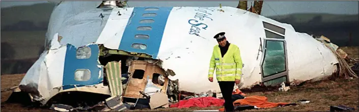  ??  ?? Carnage: A Scottish policeman beside the cockpit of Pan Am Flight 103, which was destroyed by a bomb on December 21, 1988, killing all 259 people on board and 11 in Lockerbie