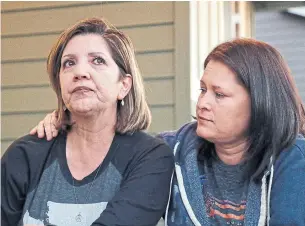  ?? ELAINE THOMPSON THE ASSOCIATED PRESS ?? Las Vegas shooting survivor Chris Gilman, right, puts her arm across her wife as tears well in Aliza Correa's eyes as they talk about the shooting a year earlier.