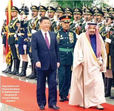  ??  ?? King Salman and Chinese President Xi Jinping inspect the guard of honor in Beijing. (Reuters)