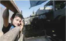  ?? — Reuters ?? Palestinia­n boy Adam Issa looks on at a cow farm in the central Gaza Strip.