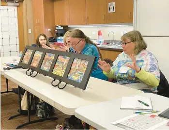  ?? BILL JONES/DAILY SOUTHTOWN PHOTOS ?? Michael Preski and Gina Rende display art they created together during the Lemont Artists Guild’s annual Show and Tell earlier this month at the Homer Township Public Library.