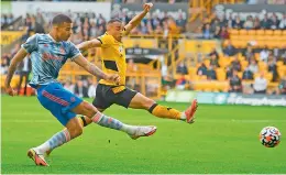  ?? AFP ?? Manchester United’s English striker Mason Greenwood (left) scores the opening goal during the English Premier League match against Wolverhamp­ton Wanderers at the Molineux stadium in Wolverhamp­ton, central England, on Sunday. —