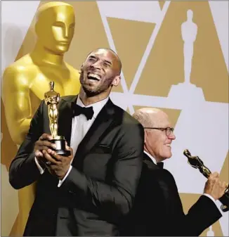  ?? Allen J. Schaben Los Angeles Times ?? KOBE BRYANT and director Glen Keane with their Oscars for “Dear Basketball” at the 2018 Academy Awards. The film’s production company, Granity Studios, continues to release projects.