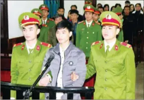  ?? VIETNAM NEWS AGENCY ?? This photo from the Vietnam News Agency taken on Monday shows activist Nguyen Van Hoa (centre) standing trial at a local people’s court in the central province of Ha Tinh.