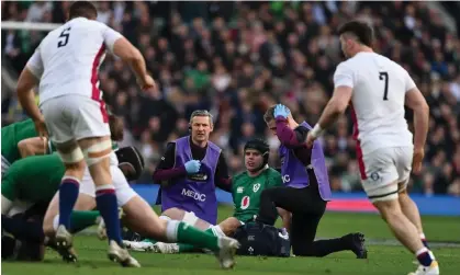  ?? Photograph: Brendan Moran/Sportsfile/Getty Images ?? Ireland’s James Ryan receives medical attention before being taken off for a head injury assessment during the Six Nations match against England in March.