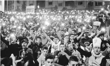  ??  ?? Protesters hold their phones as they shout slogans during a demonstrat­ion in the northern town of Al-Hoceima against official abuses and corruption in Morocco. — Reuters photo