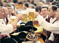  ??  ?? Thirsty work: beer-lovers raise their glasses at Oktoberfes­t in Munich, Germany