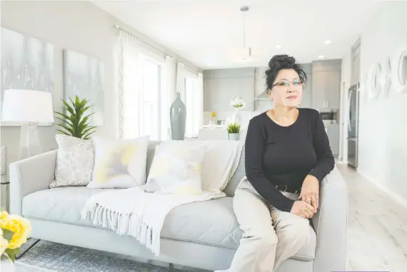  ?? DON MOLYNEAUX ?? Judy Wong says her new duplex in the Parks of Harvest Hills is “perfect,” with plenty of space to accommodat­e her adult sons.