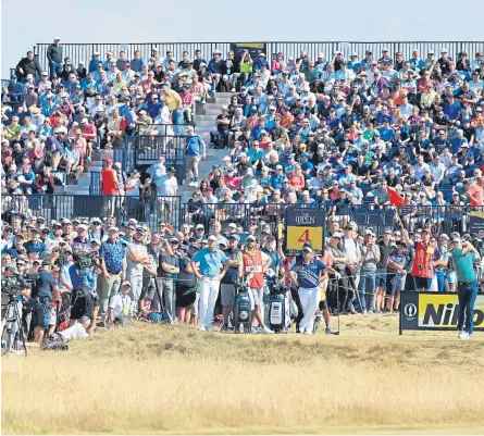  ?? Pictures: Getty/Dougie Nicolson. ?? Above: Justin Rose tees off at the fourth. Right: Dustin Johnson and his caddie share a joke. Below: Satoshi Kodaira, from Japan, blasts out of a bunker at the first.