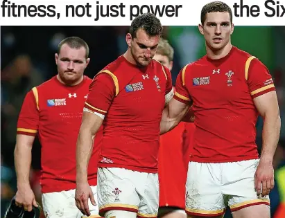  ??  ?? A different game: deflated Wales players after their agonising quarter-final defeat to South Africa