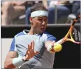  ?? ANDREW MEDICHINI — THE ASSOCIATED PRESS ?? Rafael Nadal bounced back from a Madrid Open loss by beating John Isner Wednesday in the Italian Open.