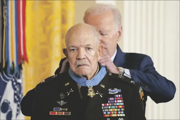  ?? EVAN VUCCI/ AP ?? PRESIDENT JOE BIDEN AWARDS THE MEDAL OF HONOR TO RETIRED ARMY COL. PARIS DAVIS for his heroism during the Vietnam War in the East Room of the White House on Friday in Washington. Davis, then a captain and commander with the 5th Special Forces Group, engaged in nearly continuous combat during a predawn raid on a North Vietnamese army camp in the village of Bong Son in Binh Dinh province.