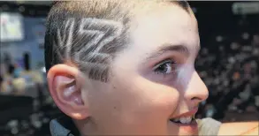  ??  ?? No 1 fan . . . Seb Stratford (10) has NZ shaved into one side of his hair and a silver fern on the other as he supports his father Nathan (below right), who is competing in the world shearing championsh­ips.