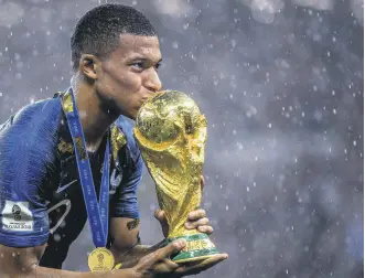  ?? ?? France’s Kylian Mbappe kisses the World Cup trophy following the 2018 FIFA World Cup Final between France and Croatia at Luzhniki Stadium in Moscow, Russia, July 15, 2018.