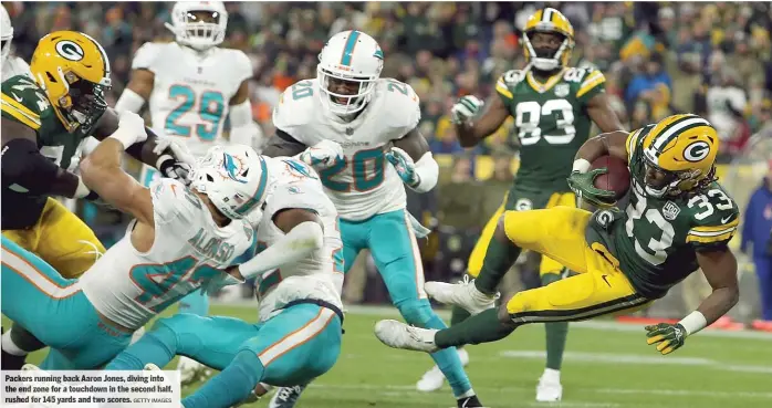  ?? GETTY IMAGES ?? Packers running back Aaron Jones, diving into the end zone for a touchdown in the second half, rushed for 145 yards and two scores.