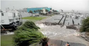  ??  ?? Sunk and damaged boats bump in the high seas at the Port St Joe Marina after Hurricane Michael struck yesterday.