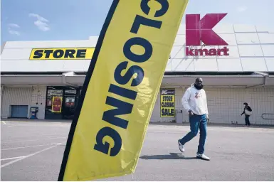  ?? SETH WENIG/AP ?? People walk through the parking lot of a Kmart on Monday in Avenel, N.J. The store is scheduled to close Saturday.