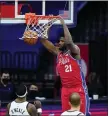  ?? MATT SLOCUM - THE ASSOCIATED PRESS ?? Joel Embiid dunks during the second half against the Jazz Wednesday, the MVP candidate scoring 40 points for the Sixers in a 131-123overtim­e win.