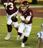  ?? MARK TENALLY — THE ASSOCIATED PRESS ?? Washington Football Team quarterbac­k Taylor Heinicke scrambles during a game against Carolina on Sunday in Landover, Md.