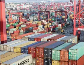  ?? PHOTO: REUTERS ?? Containers at the Yangshan Deep Water Port in Shanghai, China. China nudged up its borrowing costs overnight, as Beijing braced for new tariffs from the US.