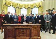  ?? Reuters ?? US President Donald Trump is surrounded by his cabinet as he signs an executive order in the Oval Office at the White House — a cabinet that is hardly a showcase of diversity.