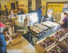  ?? ?? Volunteers organize food items before the St. James Episcopal Church annual Thanksgivi­ng food drive Thursday (Nov. 18).