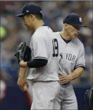  ?? CHRIS O’MEARA — THE ASSOCIATED PRESS ?? New York Yankees manager Joe Girardi, right, takes the ball from starting pitcher Masahiro Tanaka, of Japan, during the third inning of a baseball game against the Tampa Bay Rays, Sunday in St. Petersburg, Fla.