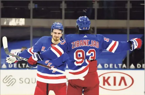  ?? Bruce Bennett / Associated Press ?? The Rangers’ Pavel Buchnevich, left, and Mika Zibanejad celebrate after they defeated the Devils on Saturday in New York. Buchnevich scored three goals.