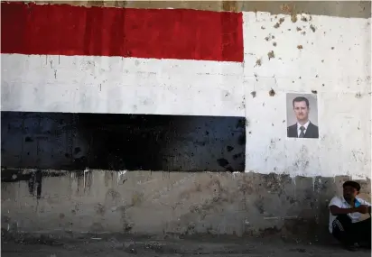  ?? (Reuters) ?? ON THE march. A poster of Syrian dictator Bashar Assad who is allied with Russia and Iran.