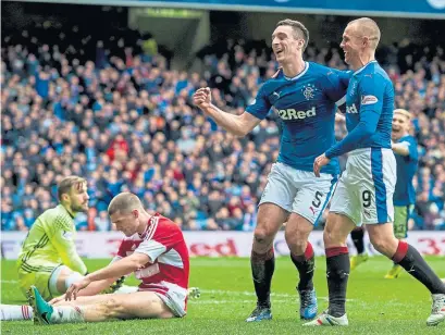  ??  ?? Lee Wallace and Kenny Miller celebrate Rangers’ fourth goal against visitors Hamilton