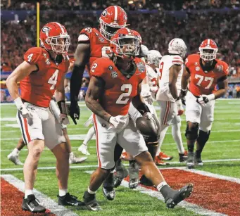  ?? JOSHUA L. JONES/ATHENS BANNER-HERALD ?? Georgia running back Kendall Milton (2) celebrates after scoring a TD against Ohio State in the Peach Bowl.