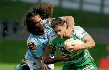  ?? GETTY IMAGES ?? Manawatu¯ ’s Kayne Hammington is tackled by Kara Pryor on a night when Northland never lost their grip on the match.