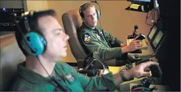  ?? Rick Loomis
Los Angeles Times ?? SGT. James Jochum, left, a sensor operator, and Capt. Sam Nelson, a drone pilot, at Creech Air Force Base in Nevada, where hundreds commute to carry out missions in Syria, Iraq, Afghanista­n and other hot spots.