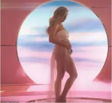  ??  ?? KATY Perry shows off her baby bump in the video of her latest track, ‘Never Worn White’.