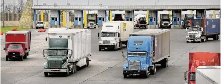  ?? Staff file photo ?? Trucks enter the U.S. at the World Trade Bridge in Laredo. The Biden administra­tion is requiring environmen­tal reviews to be complete before approving several cross-border bridge projects in Texas, a change that is costing time and money.