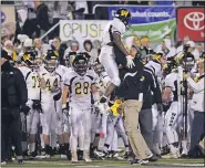  ?? MEDIANEWS GROUP FILE PHOTO ?? Archbishop Wood’s Jarrett McClenton is met by a coach on the sidelines after he scores during the second half of a PIAA high school Class AAA championsh­ip football game against Harrisburg’s Bishop McDevitt in Hershey, Pa. on Friday, Dec. 13, 2013.