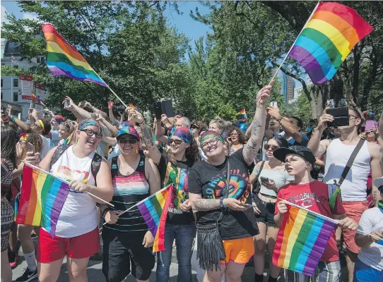  ?? PHOTOS: PETER MCCABE ?? High-spirited crowds line René-Lévesque Blvd. on Sunday to take in the colourful Pride parade. Organizers said about 7,000 people were in attendance.