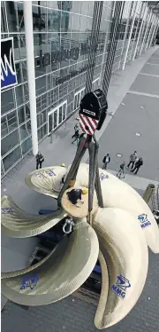  ?? /Reuters ?? For sail: A crane lifts a huge ship propeller during a shipbuildi­ng fair in Hamburg, Germany.